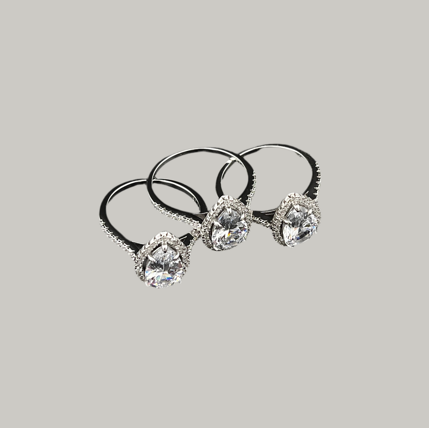 Three diamond-studded hair bands on a gray background