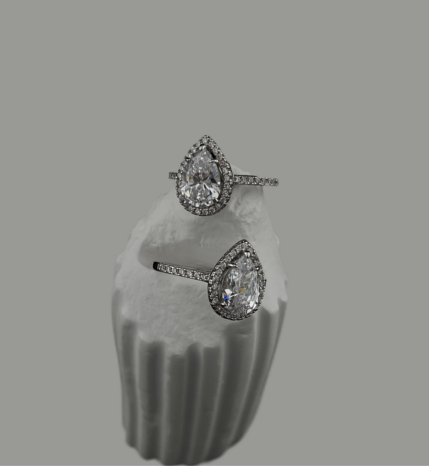 Pair of diamond earrings on a gray background