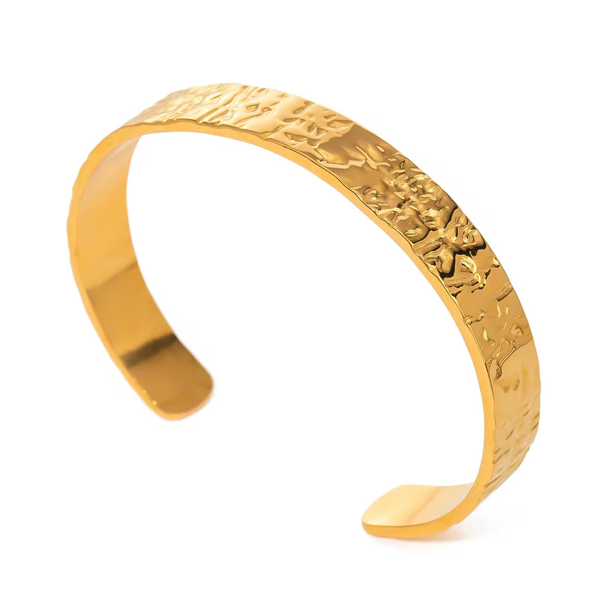 Gold bracelet with embossed design on a white background