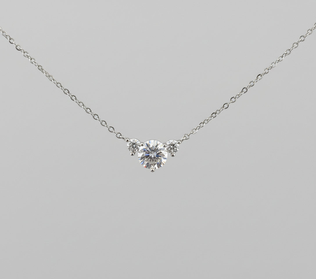 Diamond necklace on a decorative stand with ornate gold frame