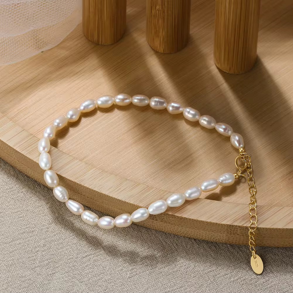 Freshwater pearl bracelet with adjustable extender and 18K gold-plated sterling silver clasp on white background.