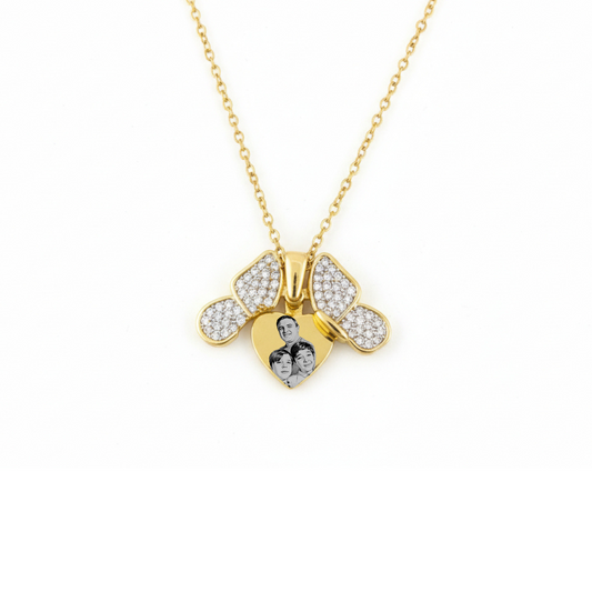 Gold bee-shaped pendant necklace with embedded stones on a white background