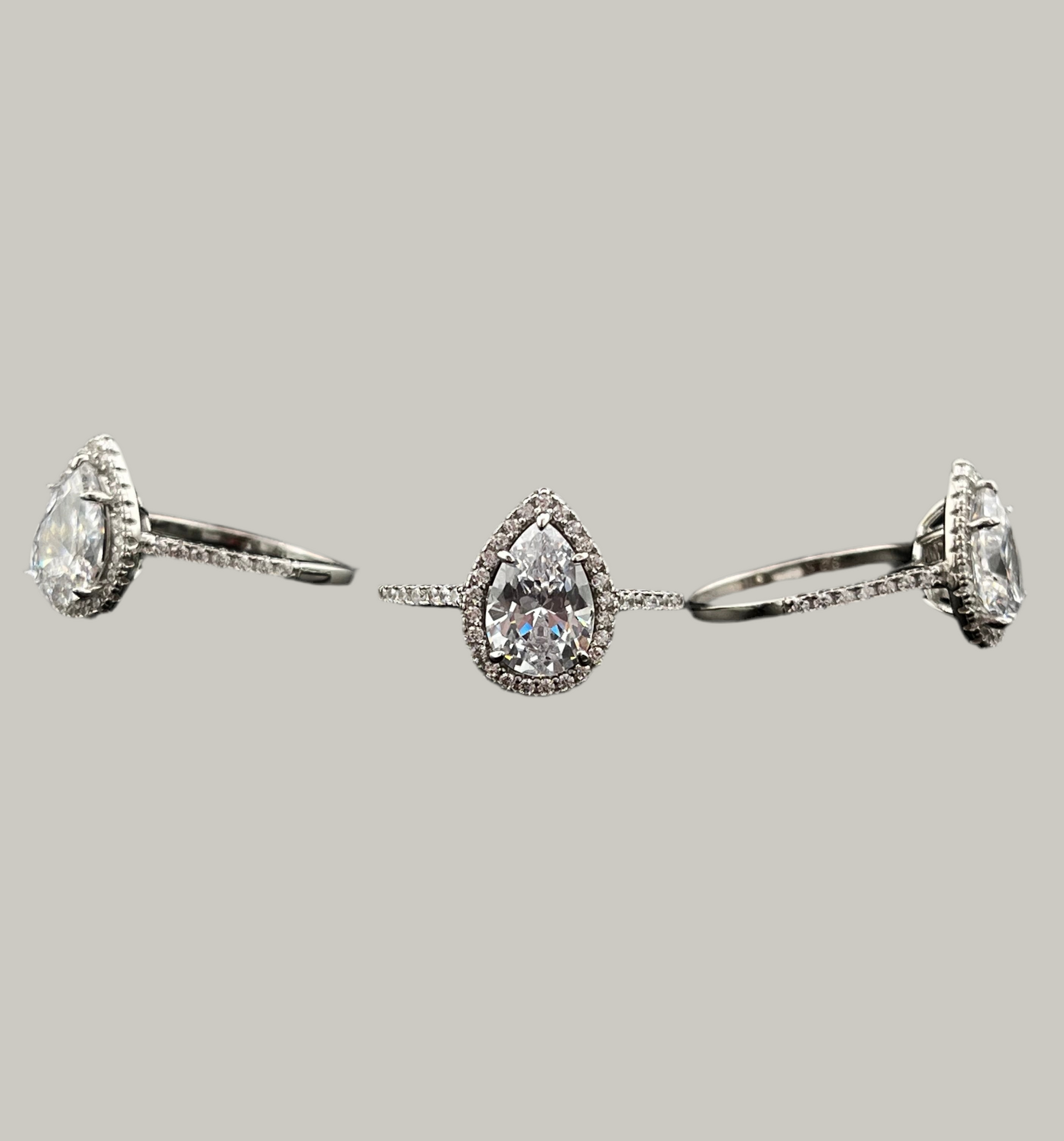 Set of silver rings with gemstones on a light gray background