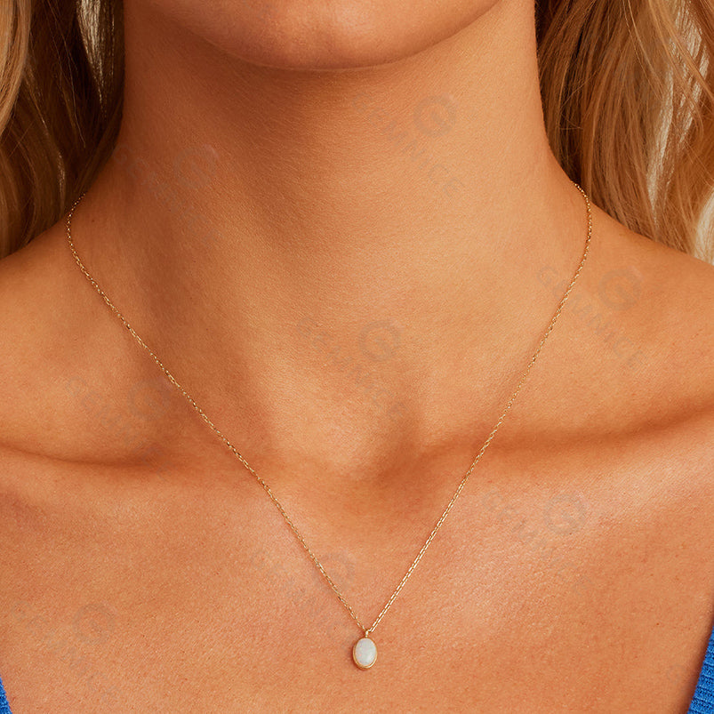 Close-up of a necklace with a pendant on a person's neck