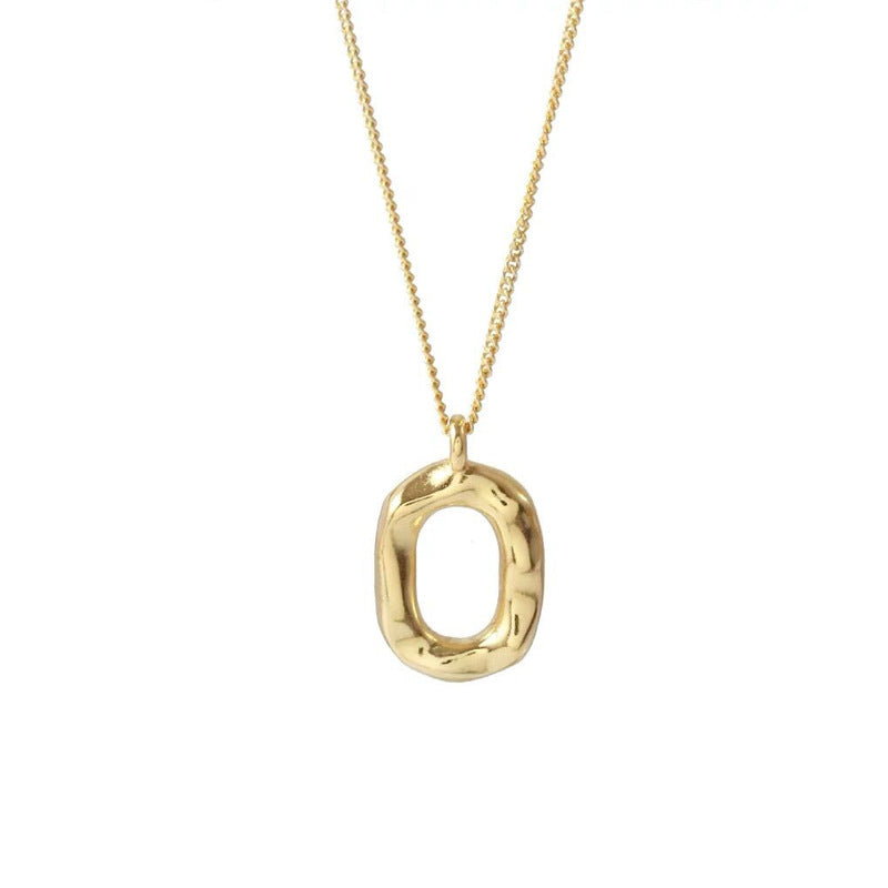 Gold necklace with an oval pendant on a white background