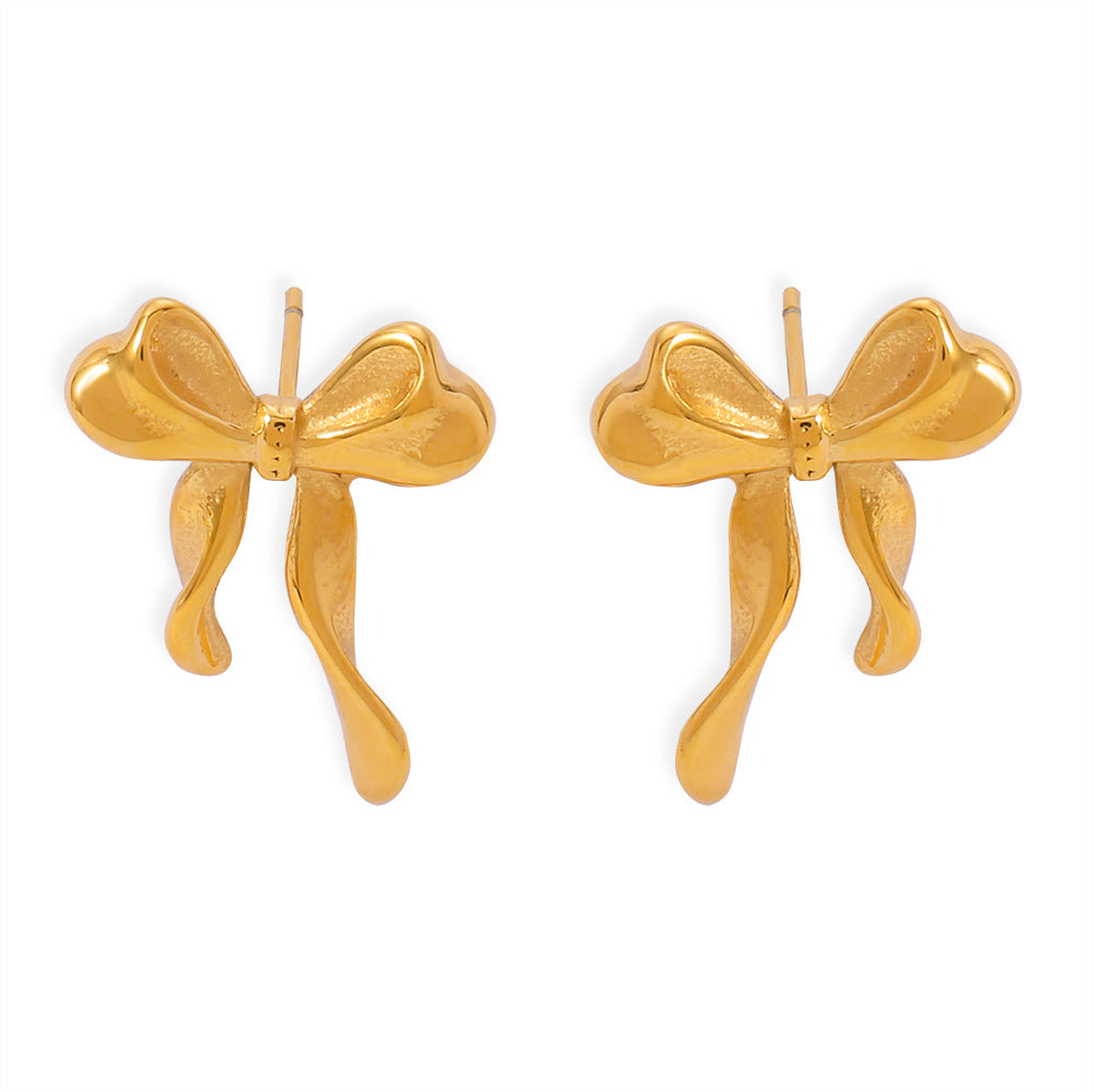 Gold bow-shaped earrings on a white background