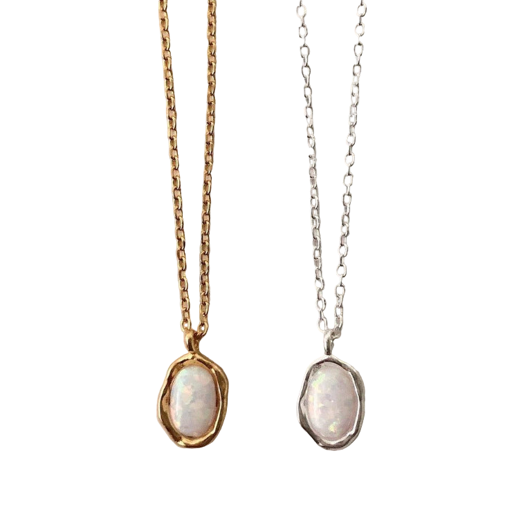 Two necklaces with pendant stones on gold and silver chains against a white background