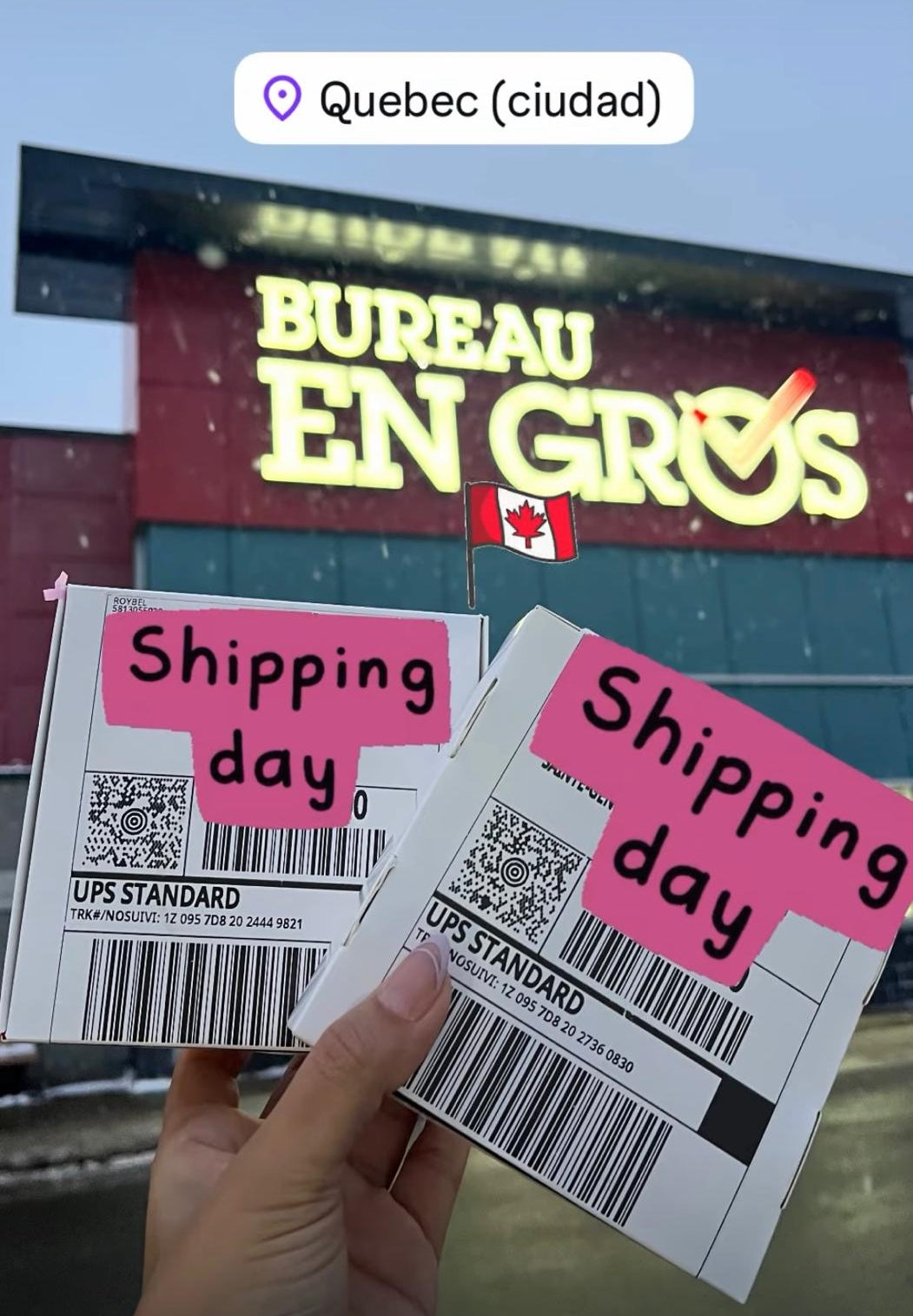 Two shipping labels with 'Shipping day' text held in front of a building with a large sign.
