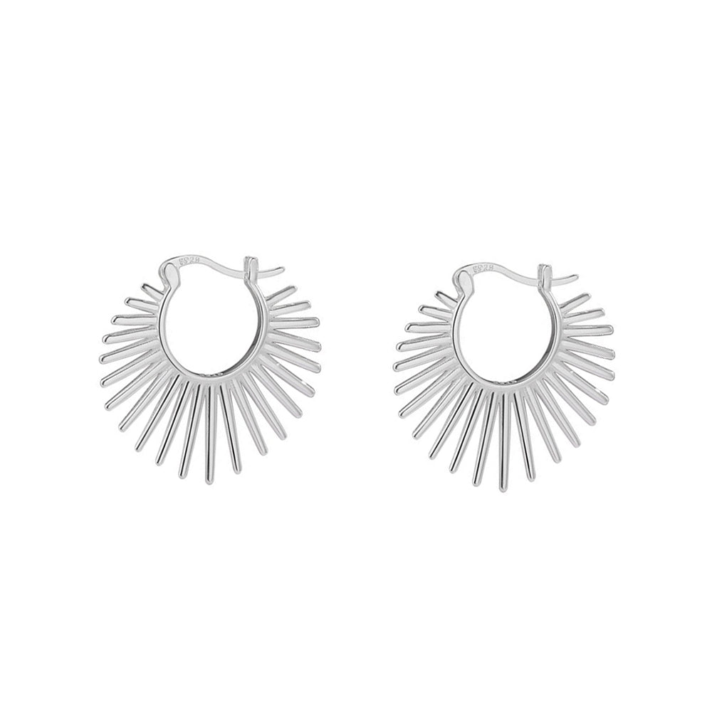 Silver hoop earrings with a sunburst design on a white background